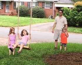 Clark with kids on swing